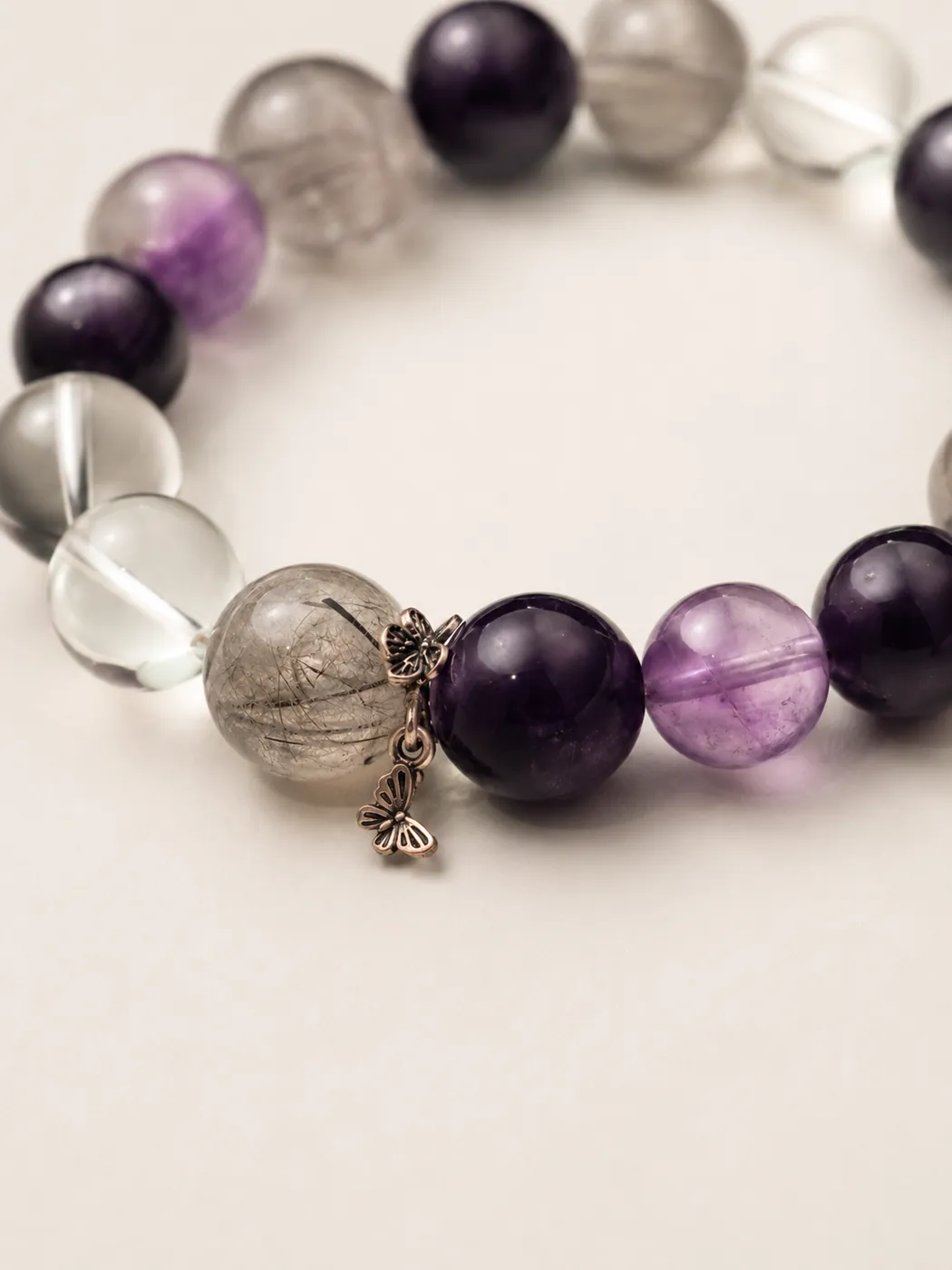 Crimson Grove Zodiac Charm Bracelet, color and texture detail, showing its distinctive color story