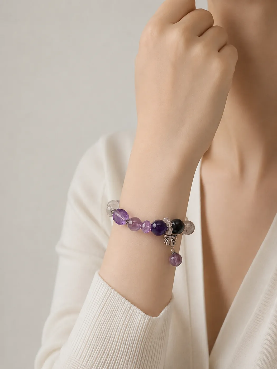 Crimson Grove Zodiac Charm Bracelet, styled on wrist, showing its distinctive color story