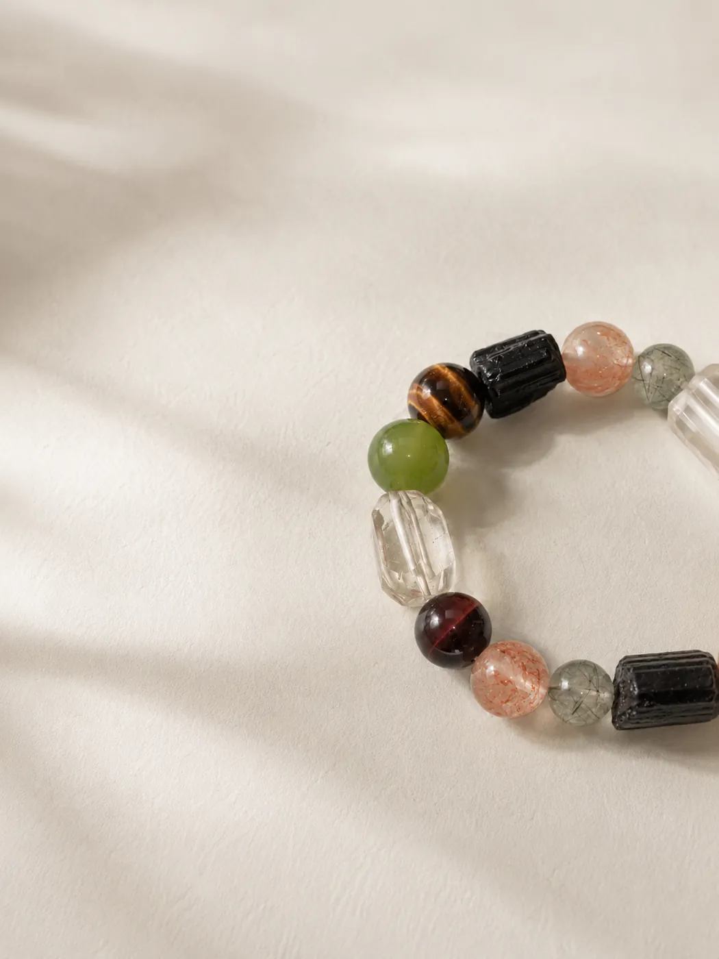 Earth & Ember Crab Charm Bracelet, editorial setting, showing its distinctive color story