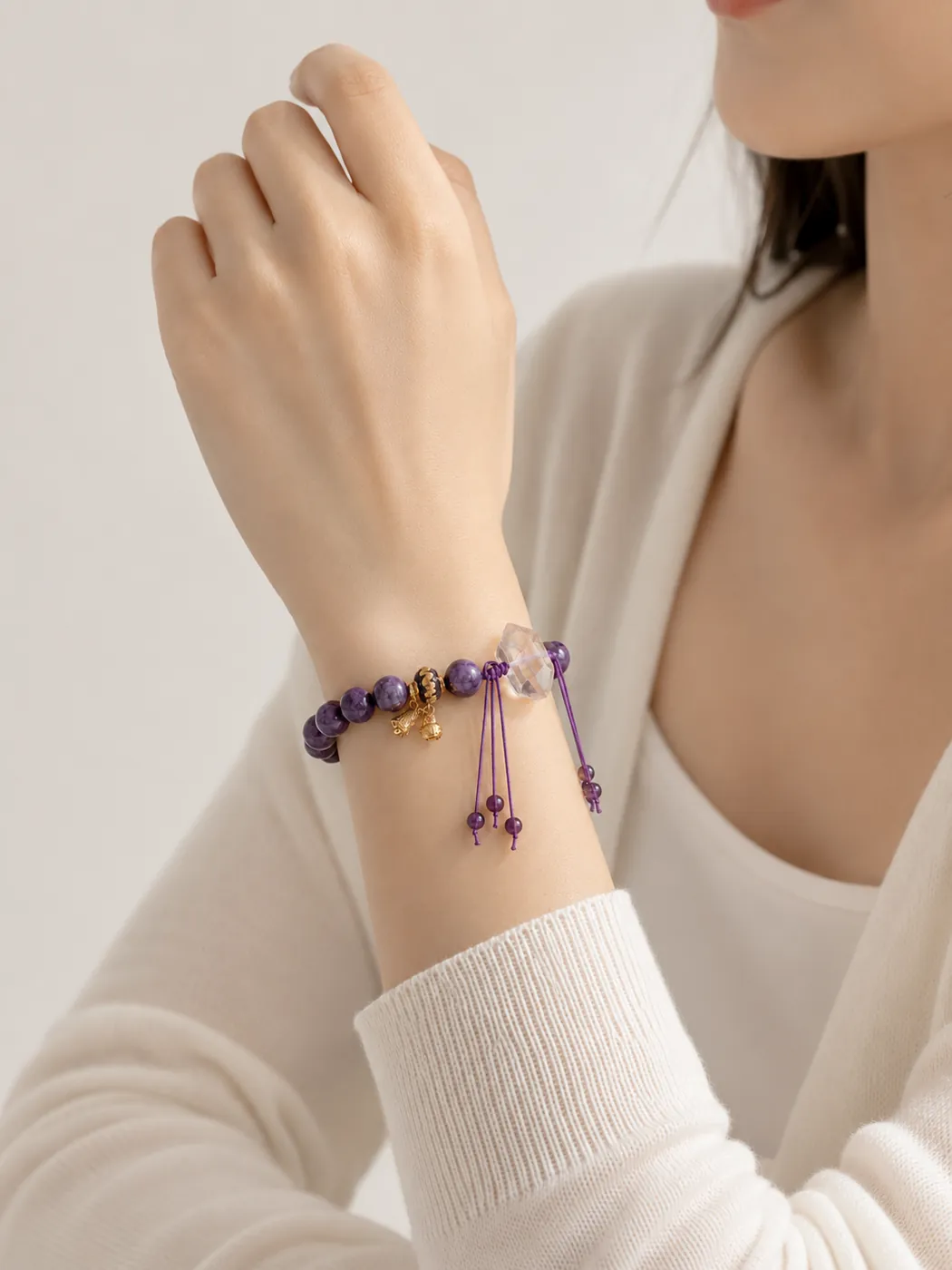 Mystic Violet Bell Charm Bracelet, styled on wrist, showing its distinctive color story