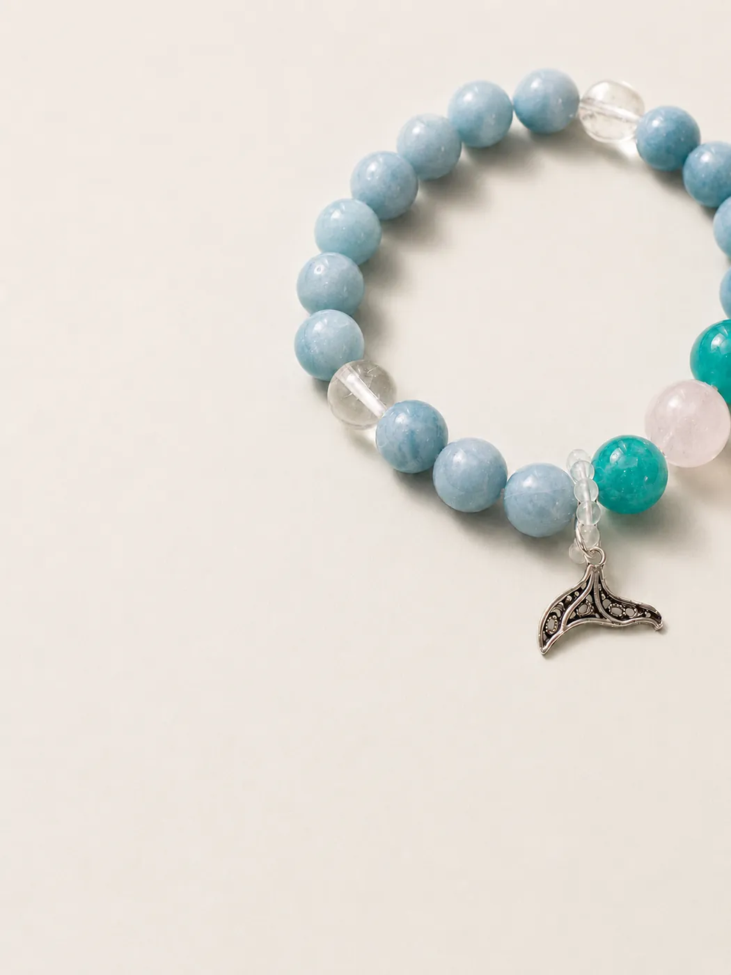 Ocean Whisper Whale Tail Bracelet, editorial setting, showing its distinctive color story
