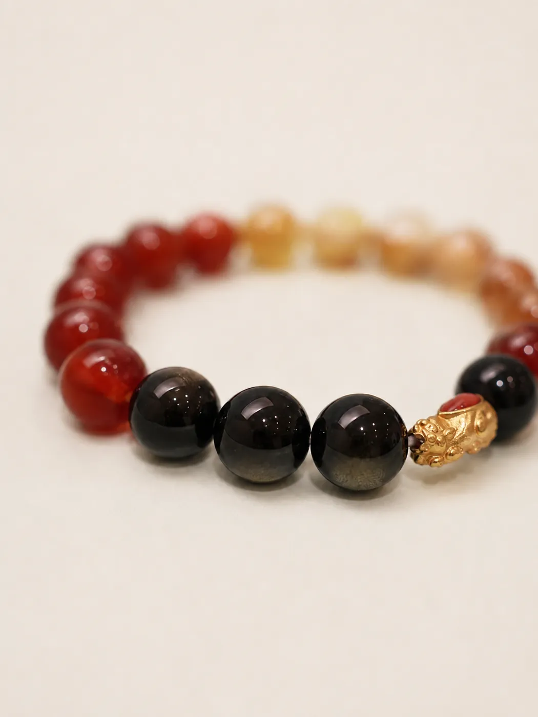 Sunset Ember Gold-Tone Accent Bracelet, bead and charm detail, showing its distinctive color story