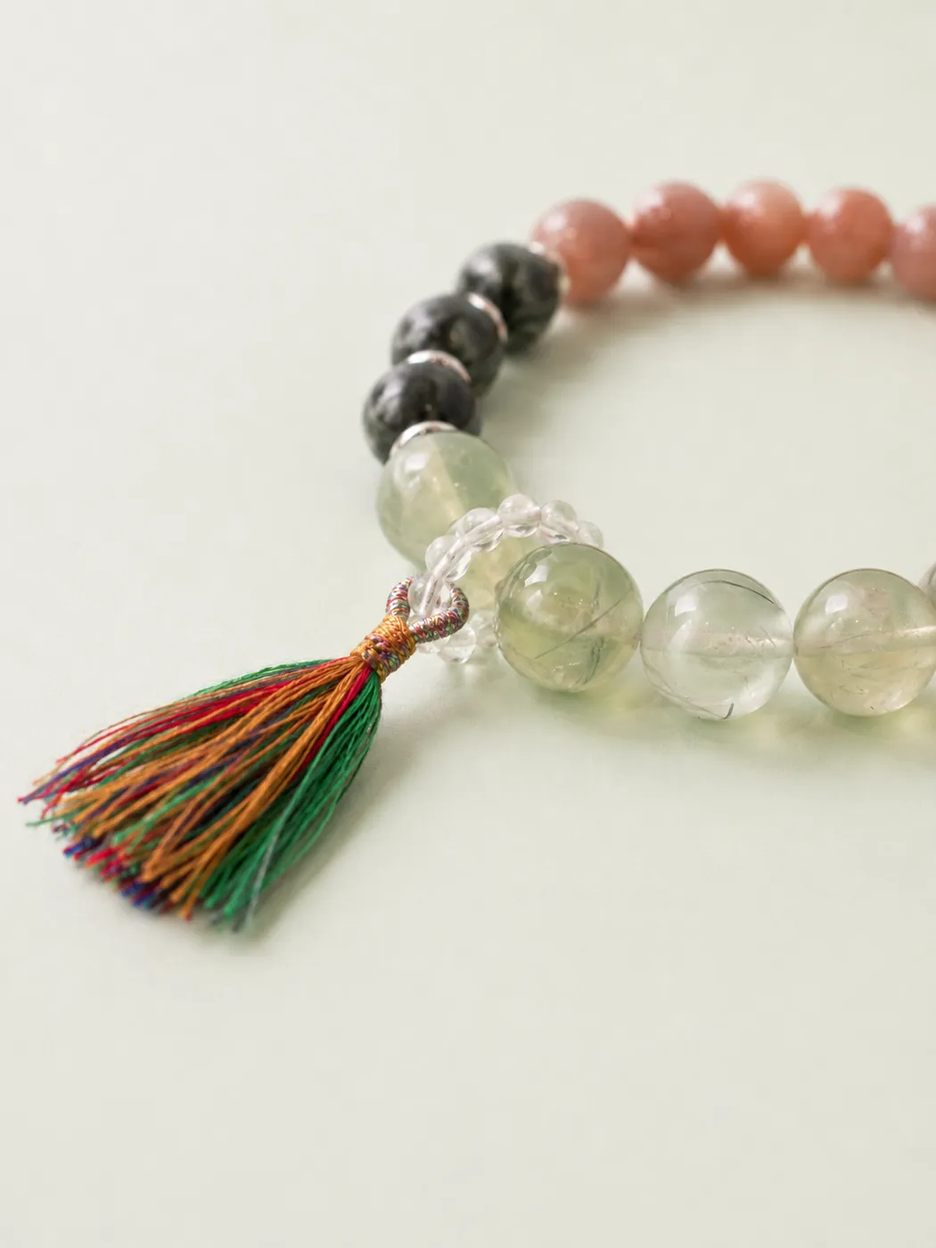Sunset Grove Tassel Bracelet, bead and charm detail, showing its distinctive color story